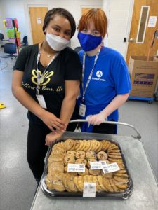 2 young women with tray of cookies