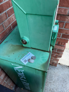 quarters laid on top of newspaper stand