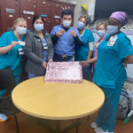 hospital staff with box of Crumbl cookies