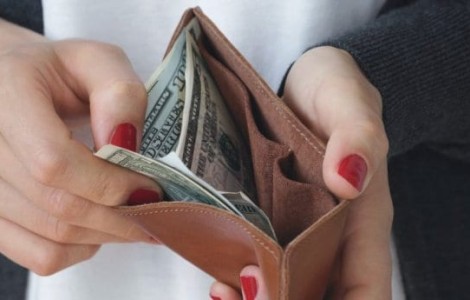 closeup of hands opening a wallet