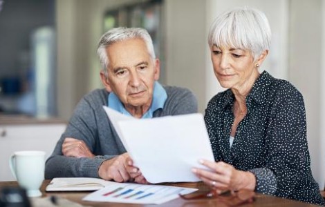 mature couple looking at retirement paperwork