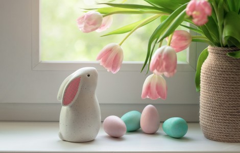 Easter bunny figurine next to flower vase