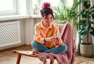 woman sitting on a chair at home on phone