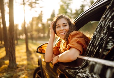 women in car looking back smiling in fall 