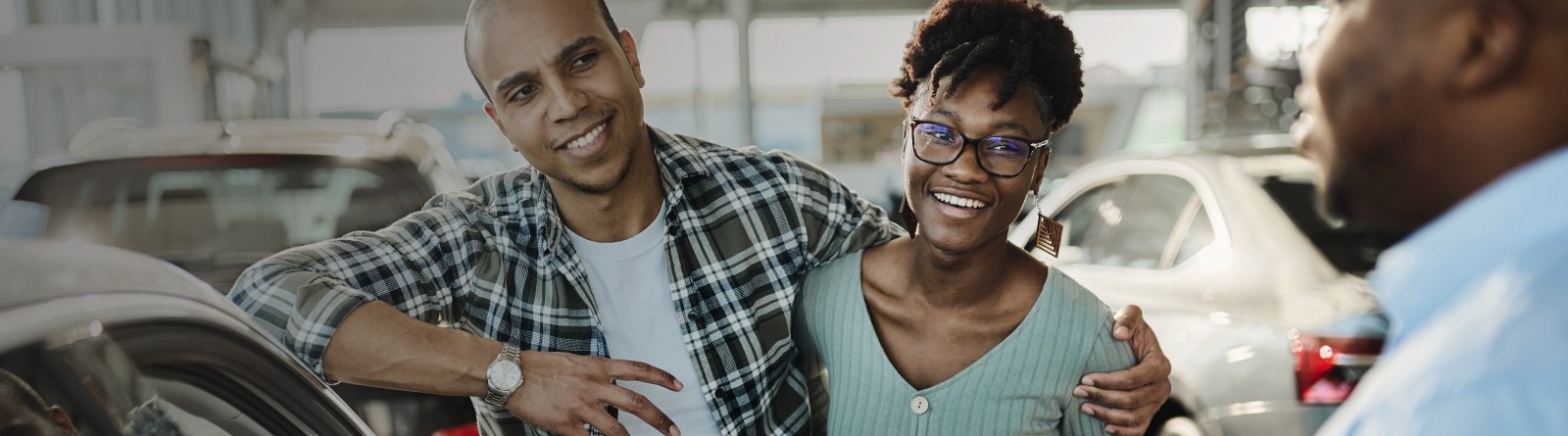 Two people meeting with an agent and smiling