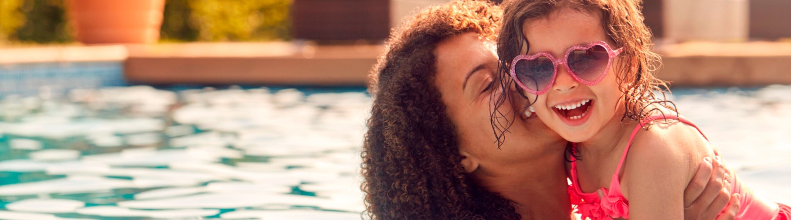 mother and daughter laughing together and swimming