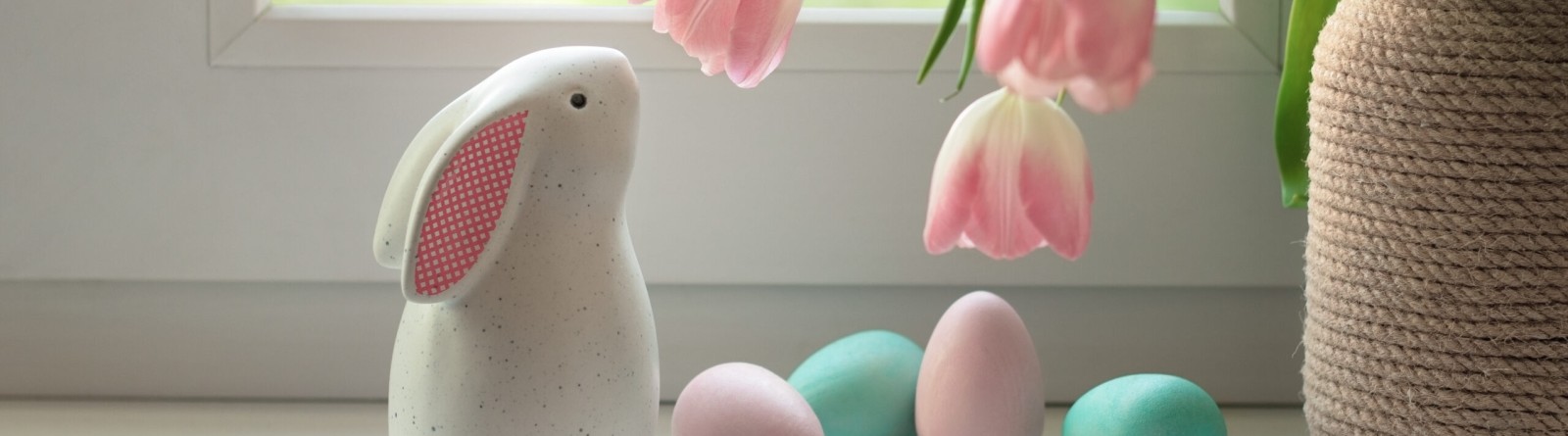 Easter bunny figurine next to flower vase