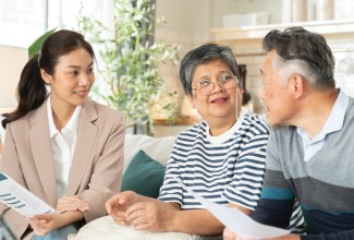 family sitting around table smiling