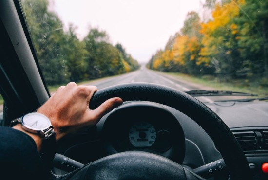 point of view of a driver steering a car while driving